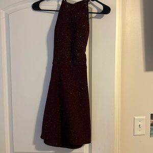 Maroon, mini dress with open back.